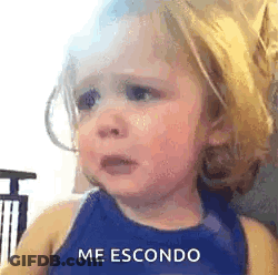 A Little Girl Is Crying And Making A Funny Face While Wearing A Blue Tank Top . GIF