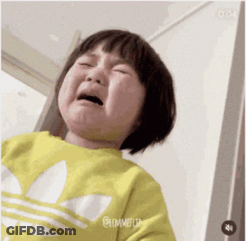 A Little Girl Is Crying And Wearing A Yellow Adidas Sweatshirt . GIF