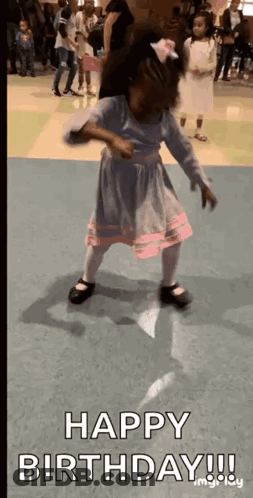 A Little Girl Is Dancing In A Room With The Words `` Happy Birthday '' Written Above Her . GIF