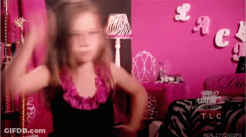 A Little Girl Is Dancing In Front Of A Pink Wall With The Word Tlc On It GIF