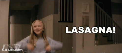 A Little Girl Is Dancing In Front Of A Sign That Says Lasagna On It GIF