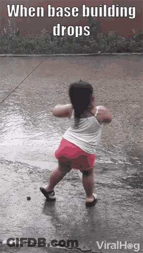 A Little Girl Is Dancing In The Rain With The Caption When Base Building Drops Viralhog GIF