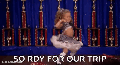 A Little Girl Is Dancing On A Stage In Front Of Trophies And The Words `` So Rdy For Our Trip '' . GIF