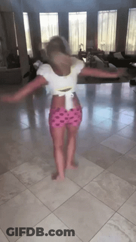 A Little Girl Is Dancing On A Tiled Floor GIF