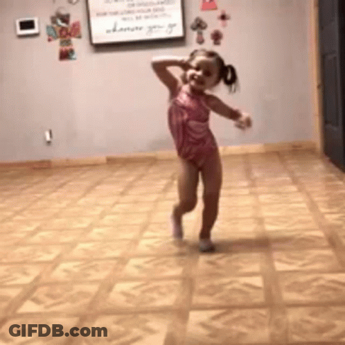 A Little Girl Is Dancing On A Tiled Floor GIF