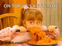 A Little Girl Is Eating A Plate Of Spaghetti With A Fork And Knife . GIF