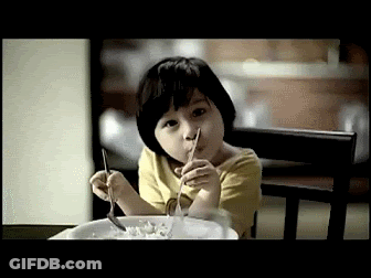 A Little Girl Is Eating Cereal With A Fork GIF