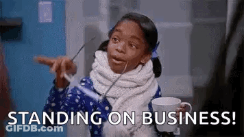 A Little Girl Is Holding A Cup Of Coffee And Pointing At Something While Standing On A Business . GIF