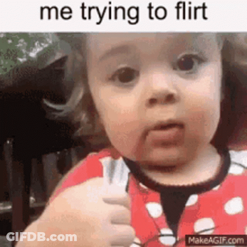 A Little Girl Is Holding A Fork In Her Hand And Making A Funny Face . GIF