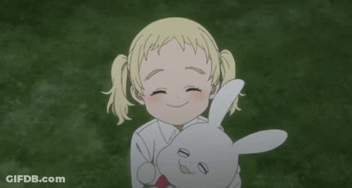 A Little Girl Is Holding A Stuffed Rabbit In Her Arms GIF