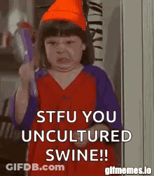 A Little Girl Is Holding A Tambourine And Making A Funny Face While Holding A Bottle Of Water . GIF
