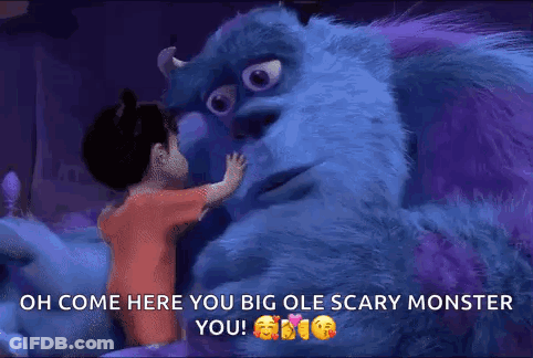 A Little Girl Is Hugging A Monster From The Movie Monsters Inc . GIF