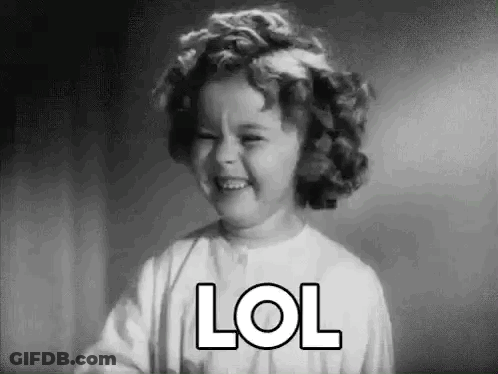 A Little Girl Is Laughing In A Black And White Photo With The Word Lol On Her Face . GIF