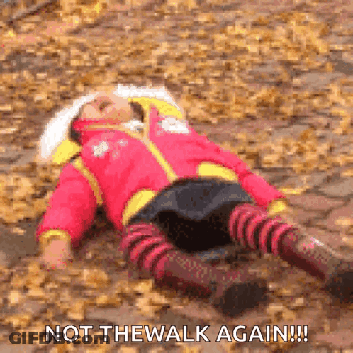 A Little Girl Is Laying On The Ground Covered In Leaves With The Words " Not The Walk Again " Above Her GIF