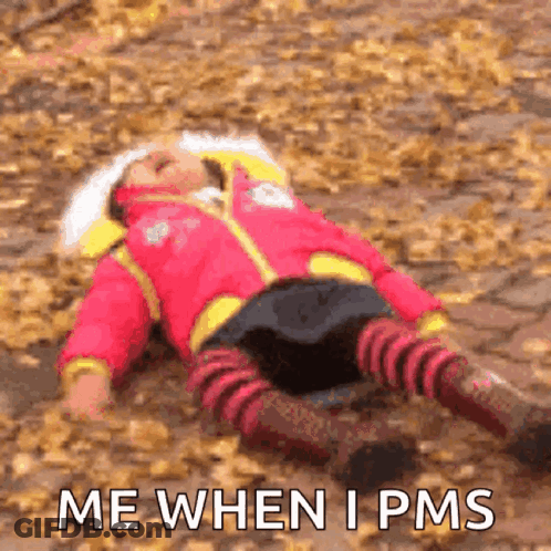 A Little Girl Is Laying On The Ground With The Words Me When I Pms Written Below Her GIF