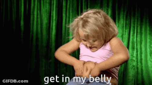 A Little Girl Is Looking At Her Belly And Says Get In My Belly GIF