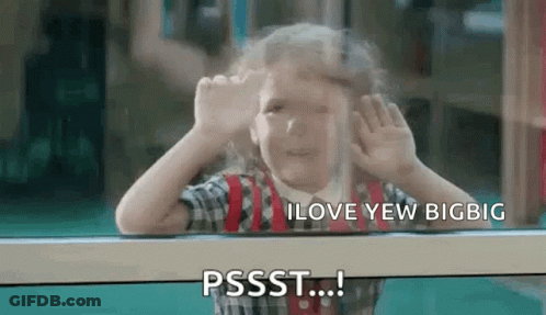 A Little Girl Is Looking Out Of A Window And Making A Face . GIF
