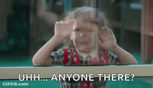 A Little Girl Is Looking Out Of A Window And Making A Funny Face With Her Hands . GIF