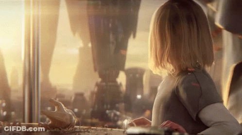 A Little Girl Is Looking Out Of A Window At A City GIF