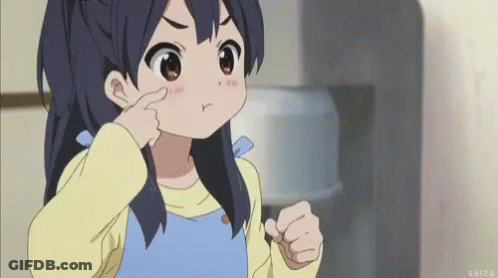 A Little Girl Is Making A Funny Face And Pointing At Her Nose . GIF