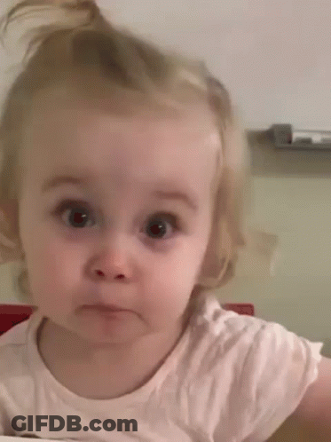 A Little Girl Is Making A Funny Face While Looking At The Camera . GIF