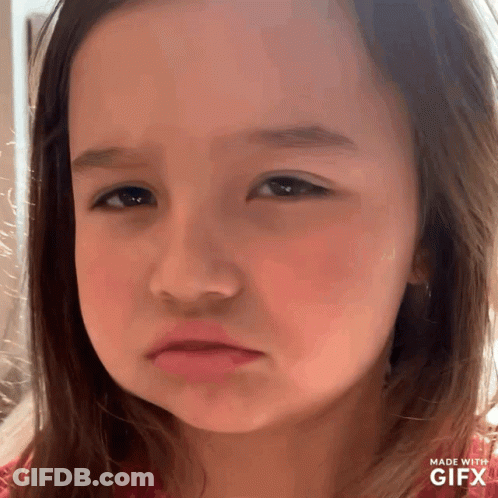 A Little Girl Is Making A Sad Face With A Gifx Watermark GIF