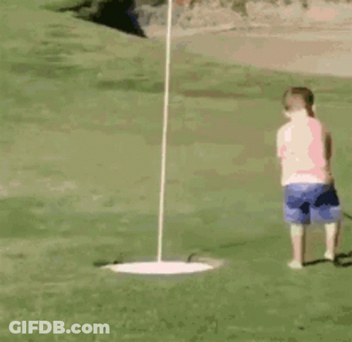 A Little Girl Is Playing Golf On The Green GIF