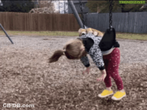 A Little Girl Is Playing On A Swing With The Words Trendizisst Written On The Bottom GIF