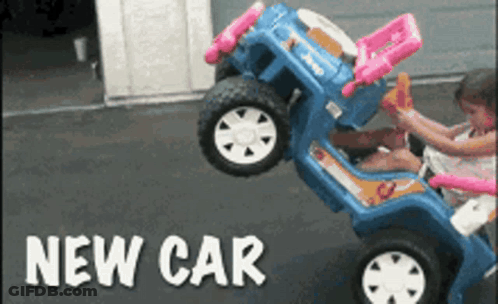 A Little Girl Is Playing With A Toy Car That Says Jeep GIF