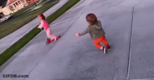 A Little Girl Is Riding A Scooter Next To A Little Boy On A Sidewalk . GIF