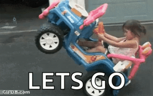 A Little Girl Is Riding A Toy Car With The Words Let 'S Go Written On It . GIF