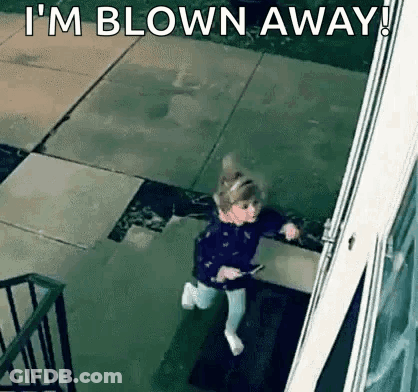 A Little Girl Is Running Out Of A Doorway With The Words `` I 'M Blown Away '' . GIF