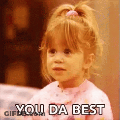 A Little Girl Is Saying `` You Da Best '' While Wearing A Pink Shirt . GIF