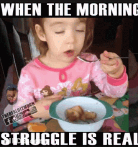 A Little Girl Is Sitting At A Table Eating A Bowl Of Food With A Spoon .. GIF