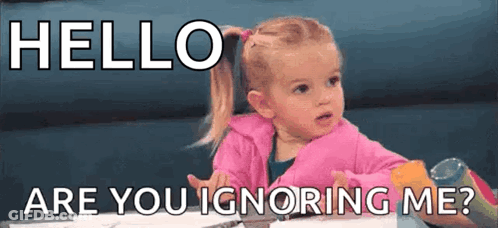 A Little Girl Is Sitting At A Table With The Words `` Hello Are You Ignoring Me ? '' Written On It . GIF