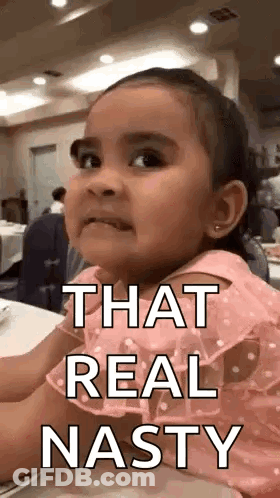 A Little Girl Is Sitting At A Table With The Words `` That Real Nasty '' On Her Face . GIF