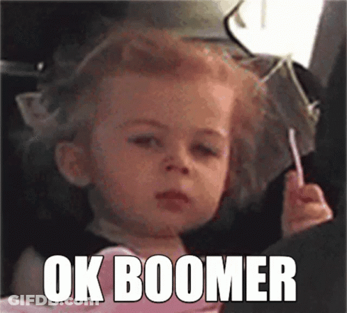 A Little Girl Is Sitting In A Car Seat Holding A Lollipop And Making A Face . GIF