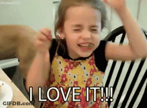 A Little Girl Is Sitting In A Chair With Her Arms In The Air And Saying I Love It . GIF