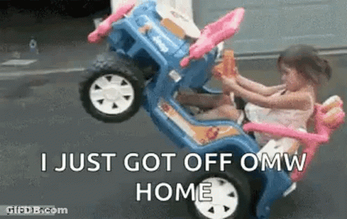 A Little Girl Is Sitting In A Toy Car With A Monkey . GIF
