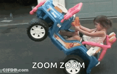 A Little Girl Is Sitting In A Toy Car With The Words Zoom Zoom Written On The Bottom . GIF