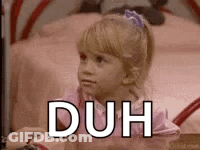 A Little Girl Is Sitting In Front Of A Bed With The Word Duh Written On Her Face . GIF
