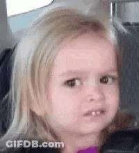 A Little Girl Is Sitting In The Back Seat Of A Car And Making A Funny Face . GIF