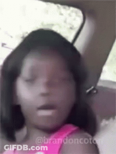 A Little Girl Is Sitting In The Back Seat Of A Car With Her Eyes Closed And Her Mouth Open . GIF
