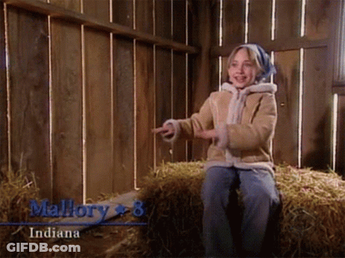 A Little Girl Is Sitting On A Bale Of Hay And The Name Mallory Is On The Bottom GIF
