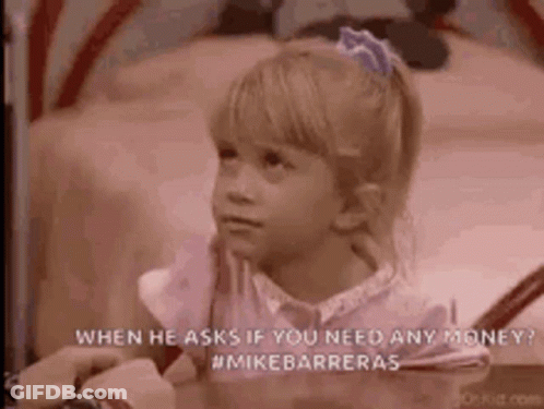 A Little Girl Is Sitting On A Bed With A Person Holding Her Hand . GIF