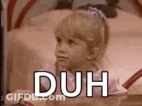 A Little Girl Is Sitting On A Bed With The Words `` Duh '' Written On It . GIF