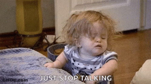 A Little Girl Is Sitting On A Couch And Making A Funny Face While Talking . GIF