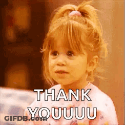 A Little Girl Is Sitting On A Couch And Saying Thank You . GIF