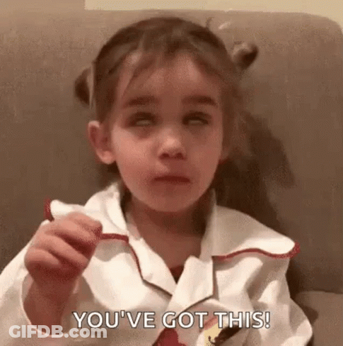 A Little Girl Is Sitting On A Couch Eating A Candy Bar And Saying `` You 'Ve Got This ! '' GIF