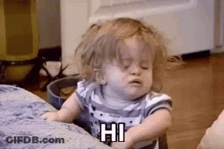 A Little Girl Is Sitting On A Couch Making A Funny Face . GIF